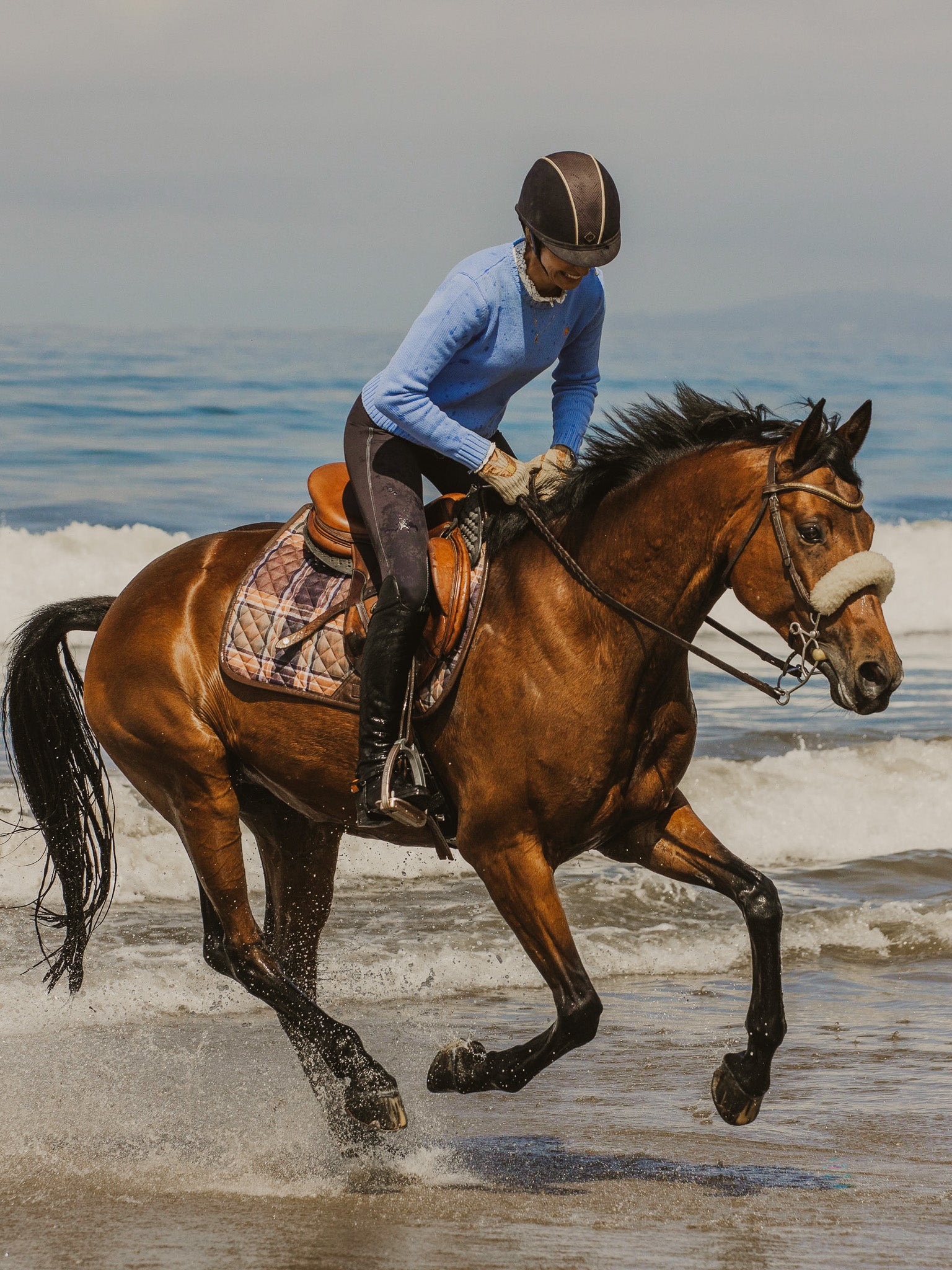 16 Cypress field plaid saddle pad on McKenzie Rollins, equestrian riding on the beach in California. 